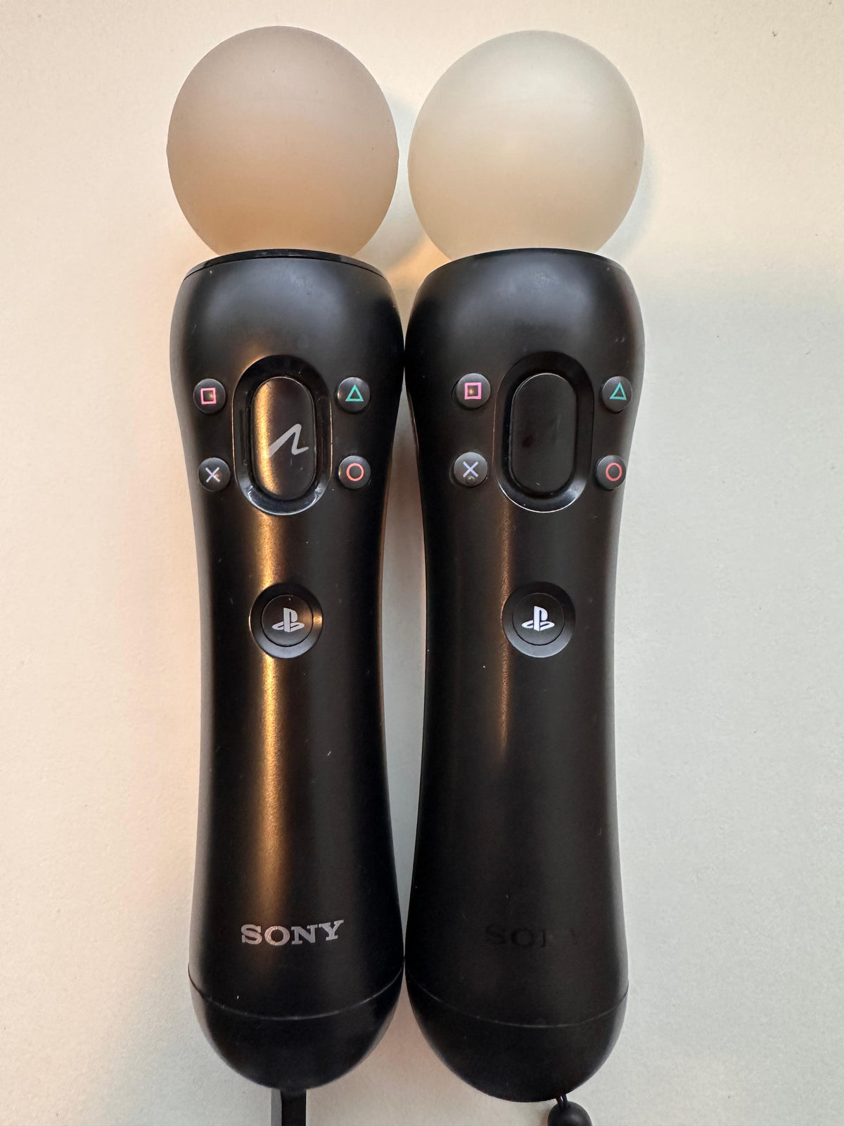 European CECH-ZCM1E and CECH-ZCM2E PlayStation Move controllers, front views side by side