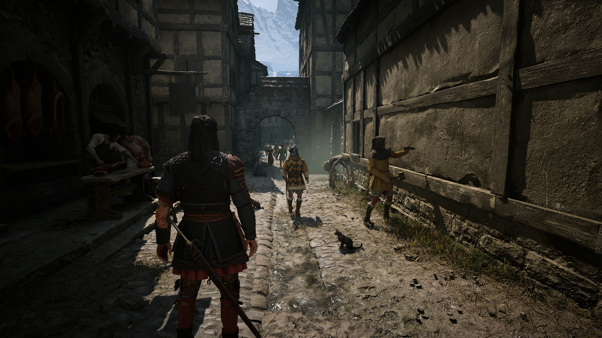 Coen walking along a stone village street in The Blood of Dawnwalker; launch-period screenshot, not Update 1.1 footage