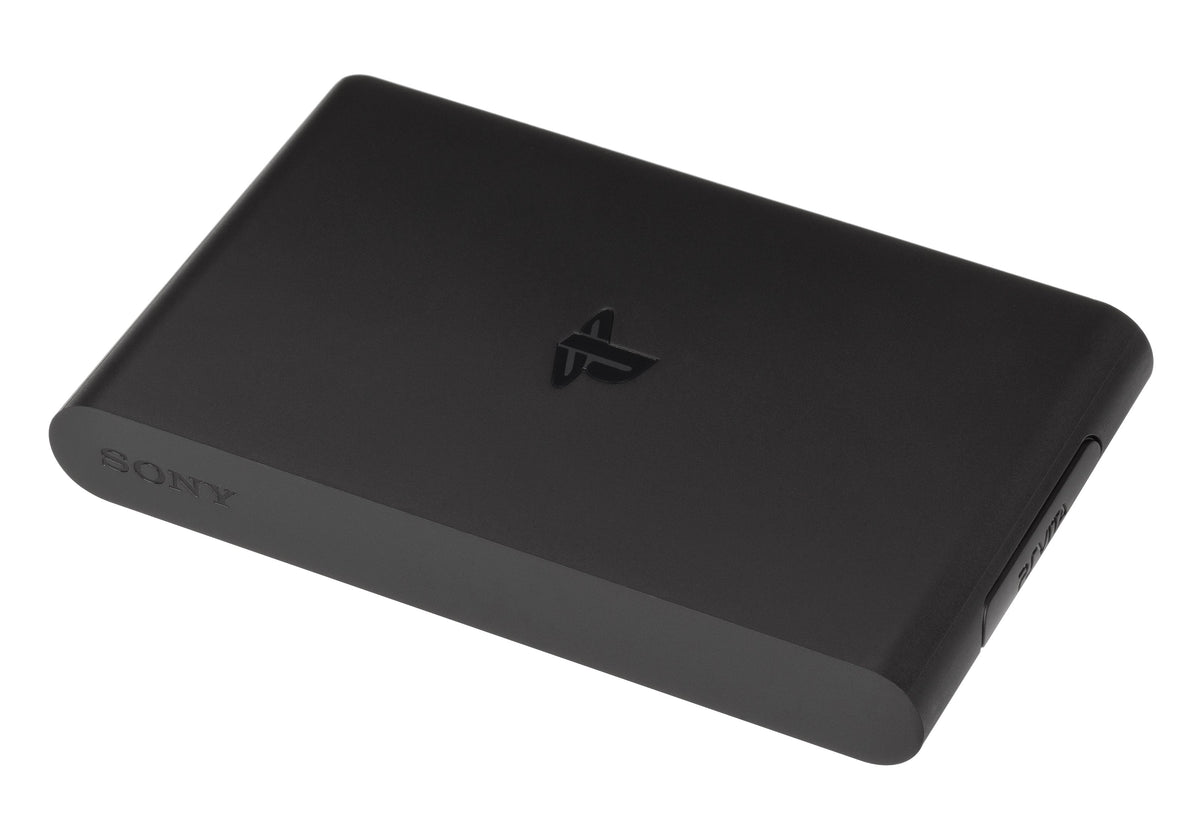 Black PlayStation TV VTE-1001 console photographed from the front left, with its PlayStation logo and side game-card cover visible