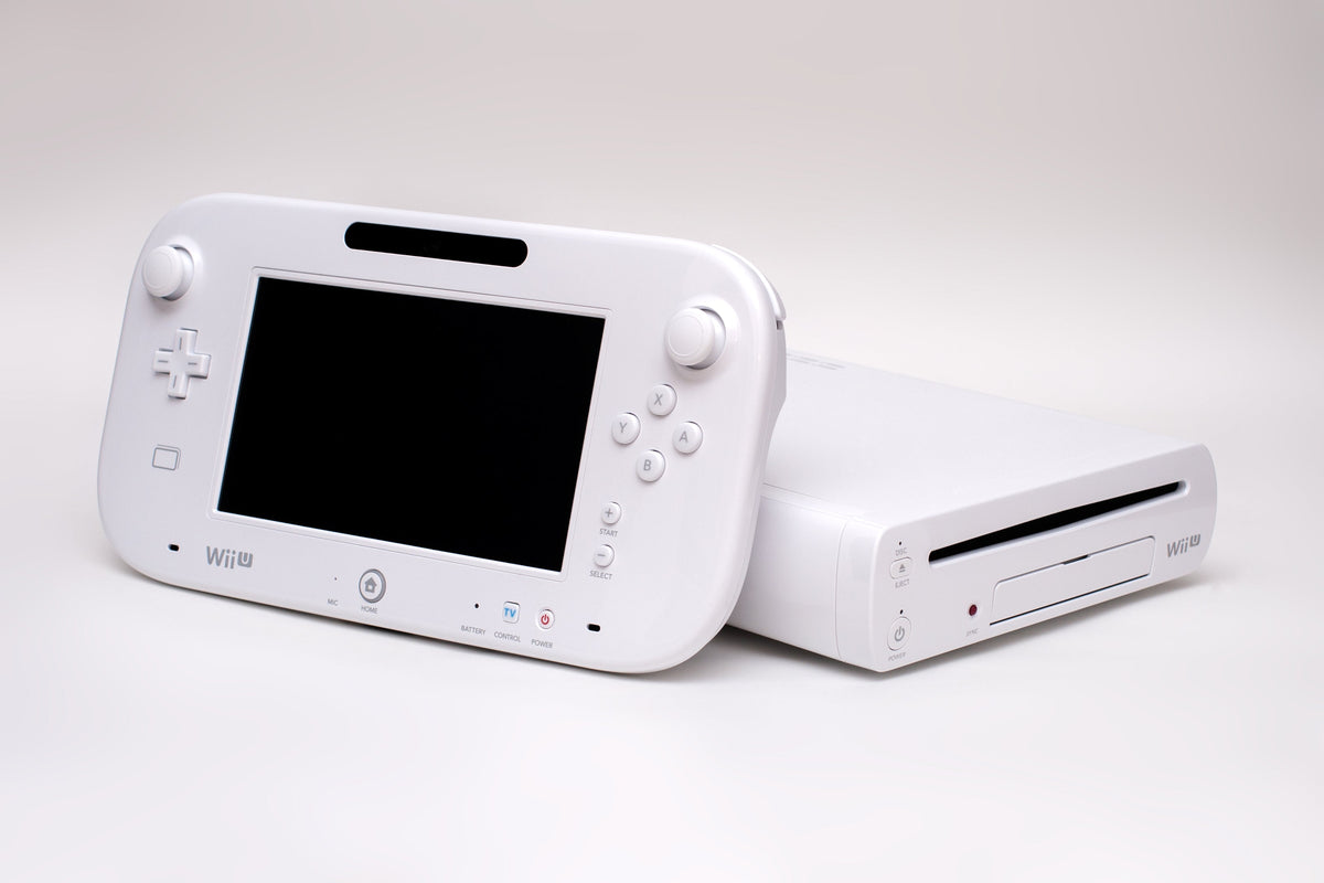 A white Wii U console and GamePad controller photographed together