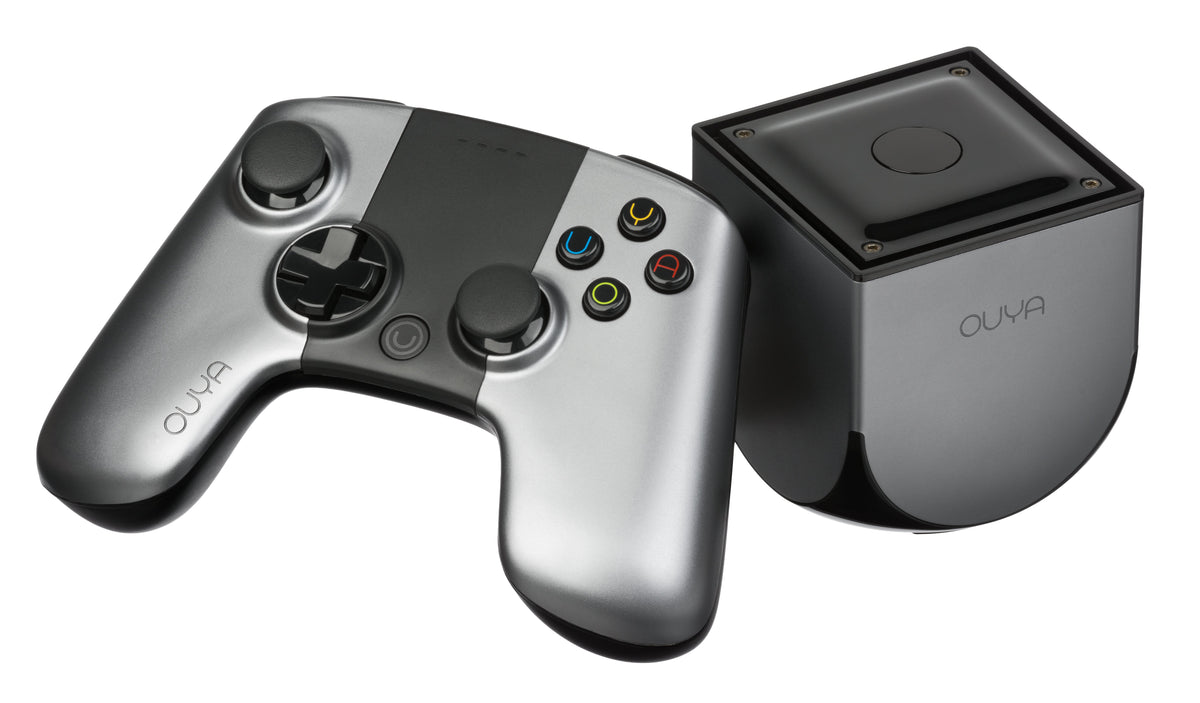 Silver OUYA console beside its gray controller