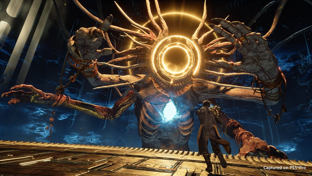 A towering multi-armed boss confronting a player character in Saros