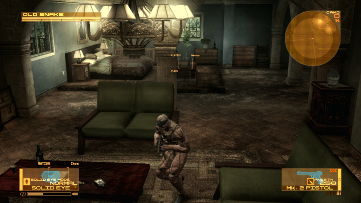 Old Snake crouches in a furnished room, wearing OctoCamo with a mottled surface pattern.