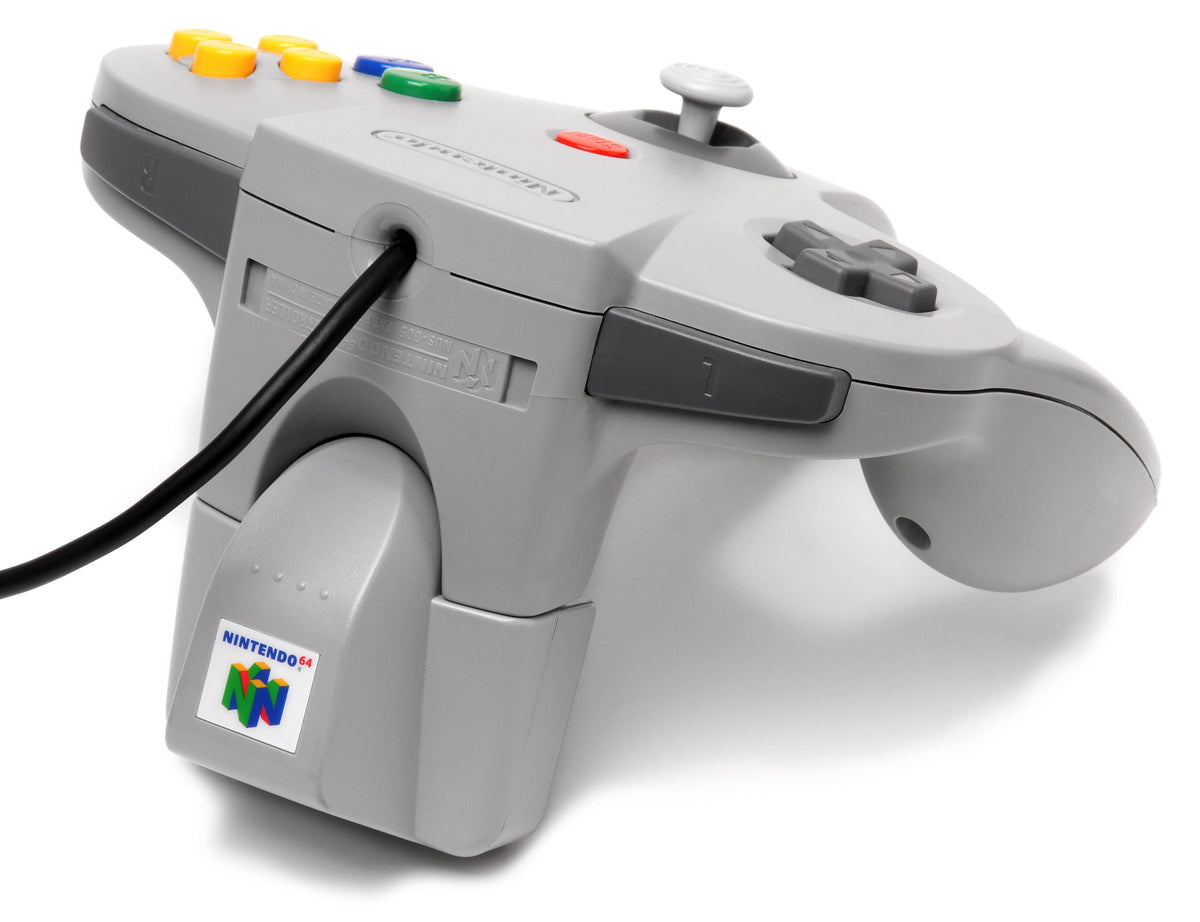 Rear view of an original Nintendo 64 controller with a gray Rumble Pak attached