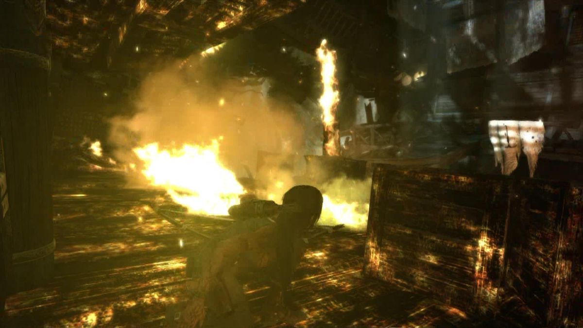 Lara Croft exploring a burning area in Tomb Raider gameplay on Xbox 360