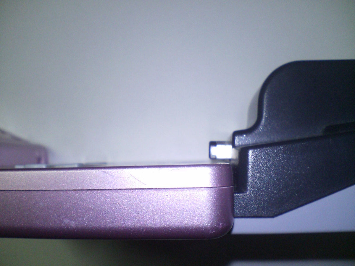 Nintendo e-Reader attached to the cartridge slot of a blue Game Boy Advance SP