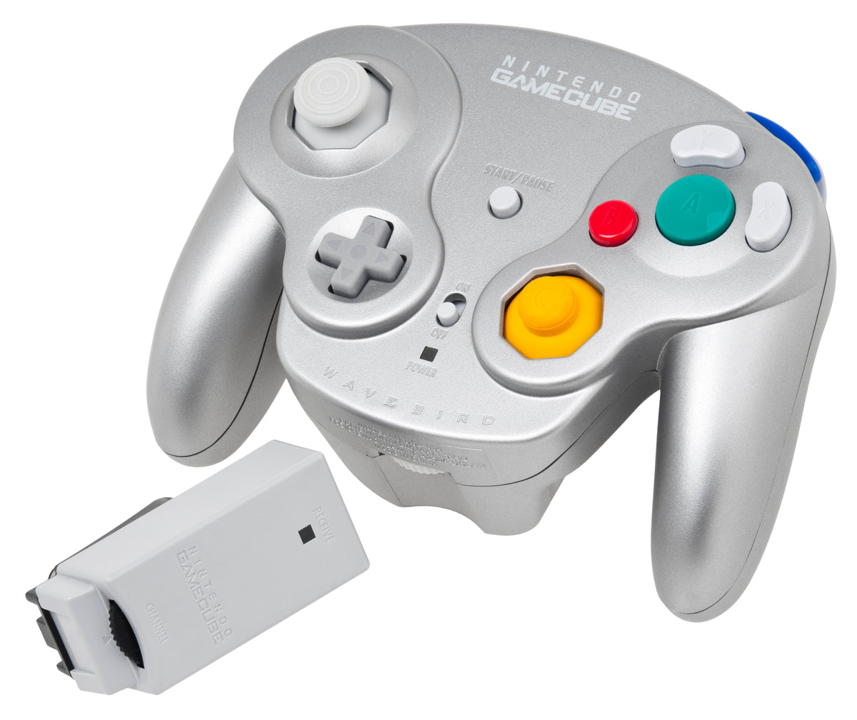 Silver Nintendo WaveBird controller beside its separate wireless receiver on a white background