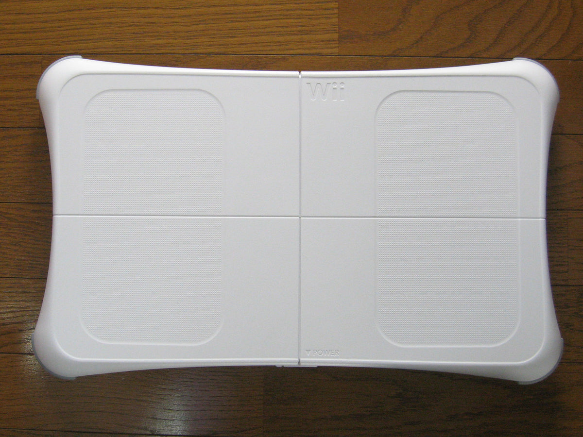White Nintendo Wii Balance Board photographed from above on a wooden floor