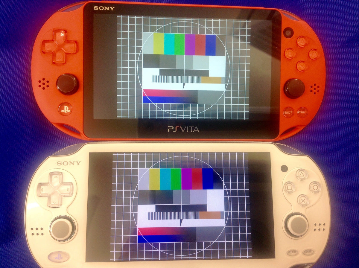 White PCH-2000 and black PCH-1000 PlayStation Vita handhelds shown together