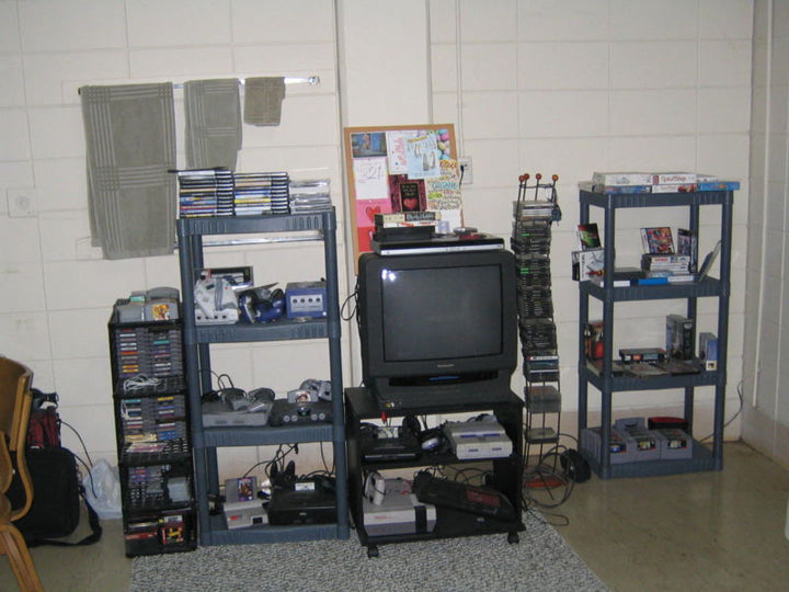 Large physical video game collection with games and consoles