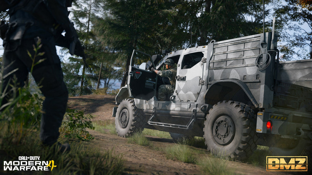 An operator entering an armored military vehicle alongside another armed teammate in a wooded setting.