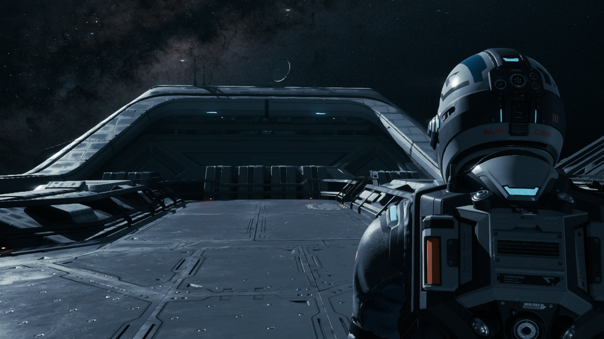A helmeted crew member looks across a spacecraft deck in Directive 8020