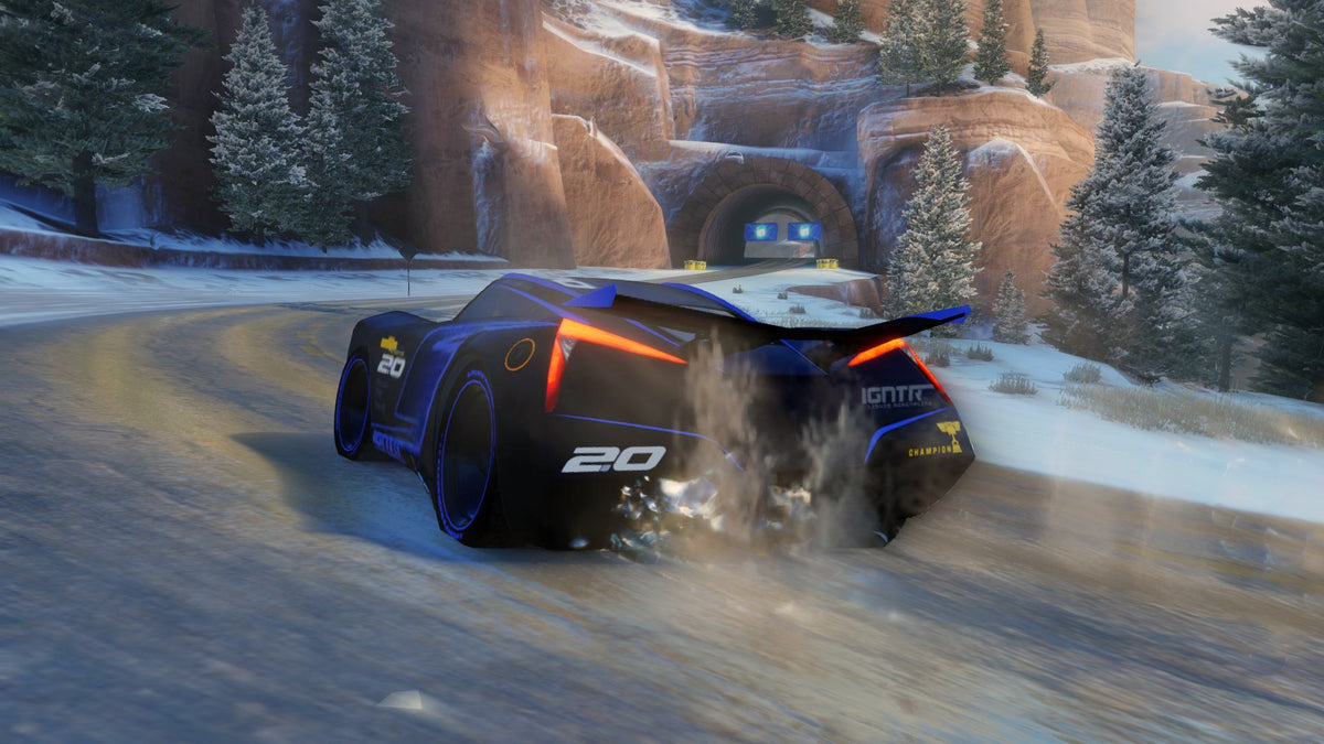 Cars 3: Driven to Win | Xbox One | gameplay screenshot | Drifting toward a tunnel on a snowy mountain track | source=official Xbox BZKS084ZSXJ4 | asset=62df05b5-7d99-4559-a300-ac071c0b94d7